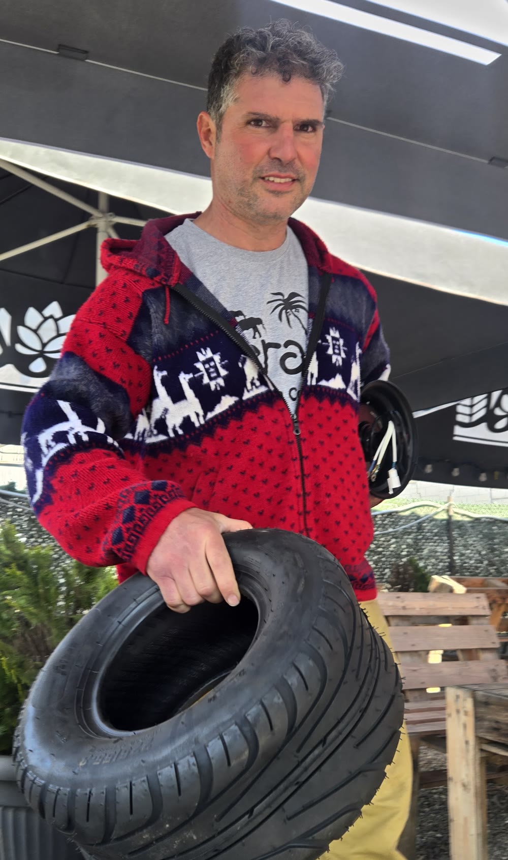 Eyal Aloni, mechanical engineer and founder of TLT Board, holding a TLT Board tire