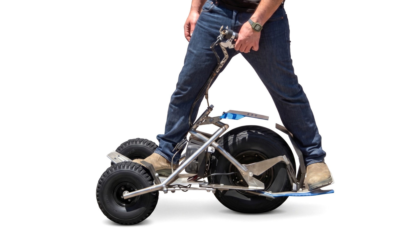 Rider standing over the TLTboard Marlin electric all-terrain board, close-up of legs and wide off-road tires